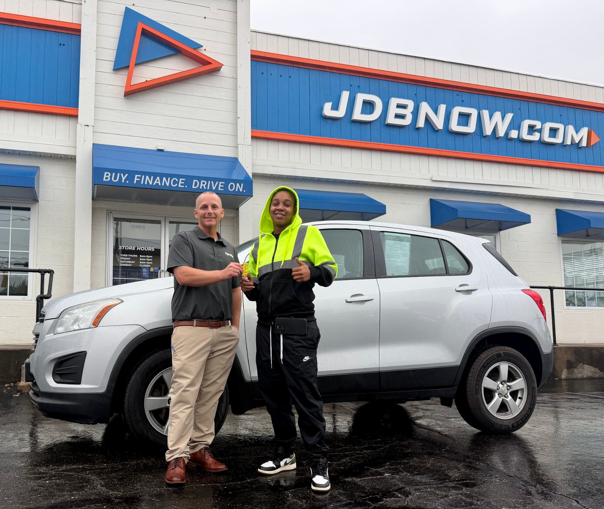 Byrider Canton customer and salesperson with their used Chevrolet Trax at the Canton, Ohio dealership