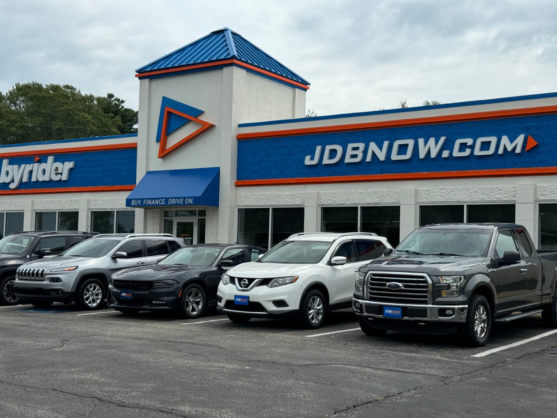 Byrider Ashtabula used car dealership storefront at 3420 N Ridge Rd E, Ashtabula, Ohio, with SUVs and a Ford F-150 parked out front